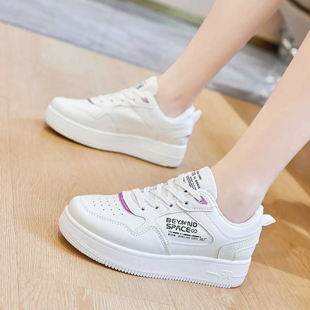 White sneaker with letter print.