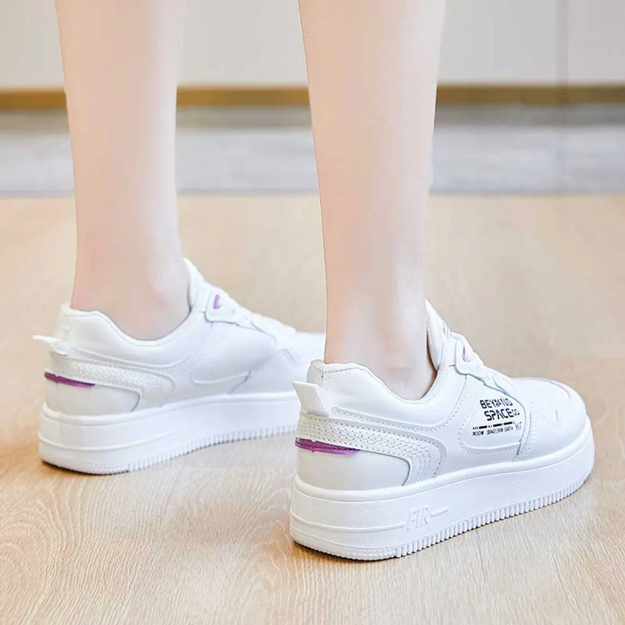 White sneaker with letter print.